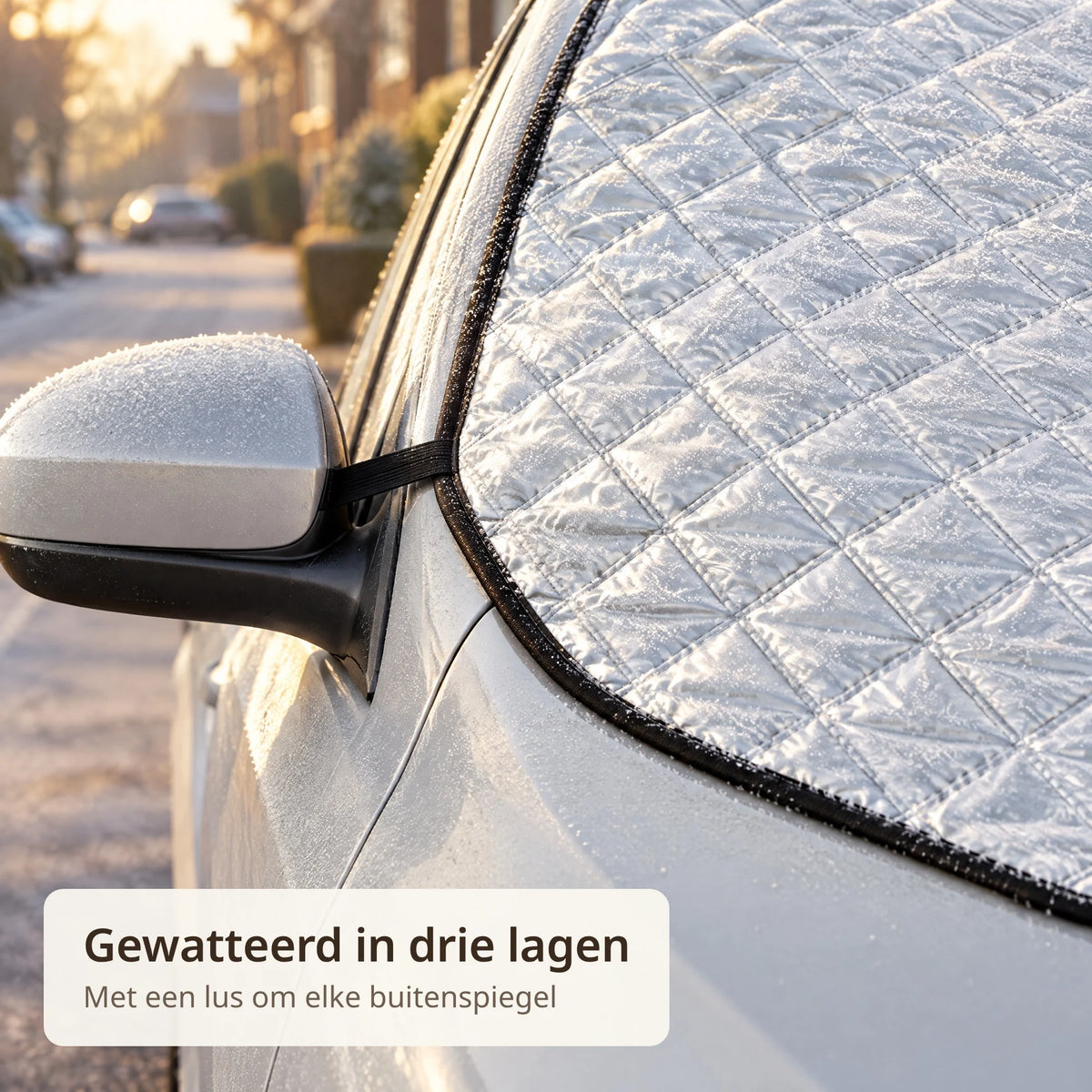 Close-up van de gewatteerde zilveren voorruithoes met zwarte rand en een lus om de buitenspiegel